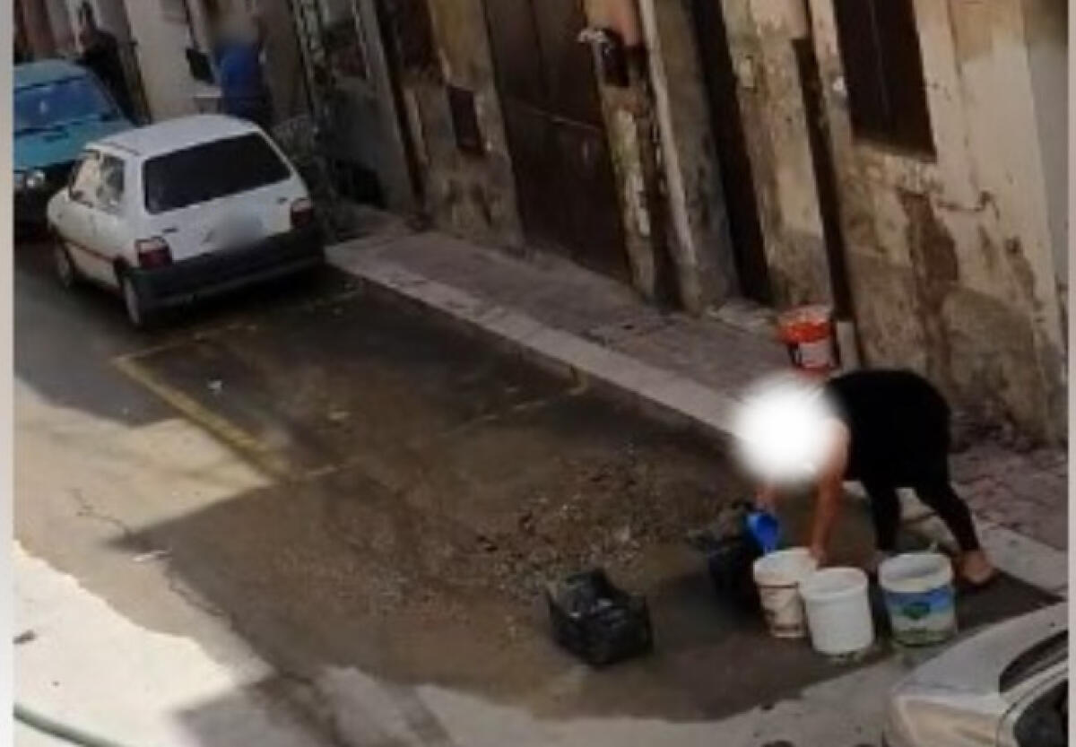 L'acqua attinta dalla strada, quartieri allo stremo e una città in emergenza continua - L'acqua attinta da una fuoriuscita in strada
