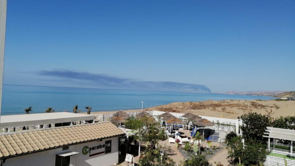 Una vasta nube scura a ridosso della città, forse l'ennesimo maxi rogo - La nube ben visibile dalla città